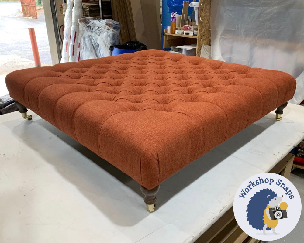 large square soft orange fabric footstool with buttons
