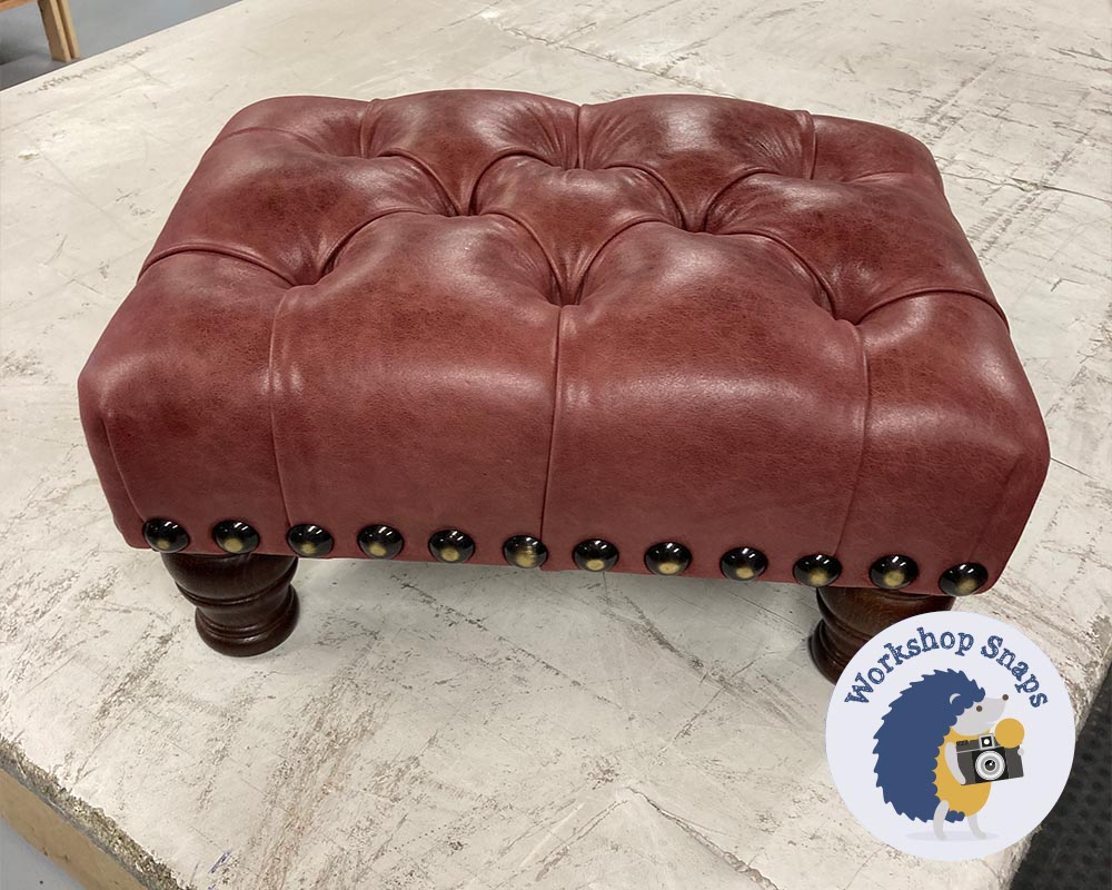 Very small rectangle padded footstool in oxblood leather with buttons
