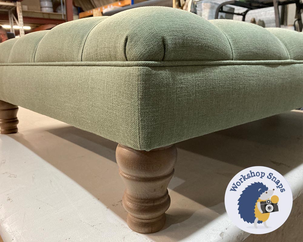 Large rectangle pale green linen padded footstool with buttons