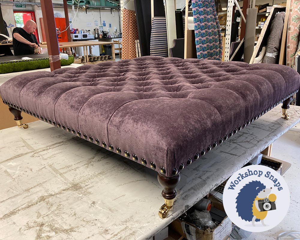 large aubergine coloured velvet footstool with buttons and studs