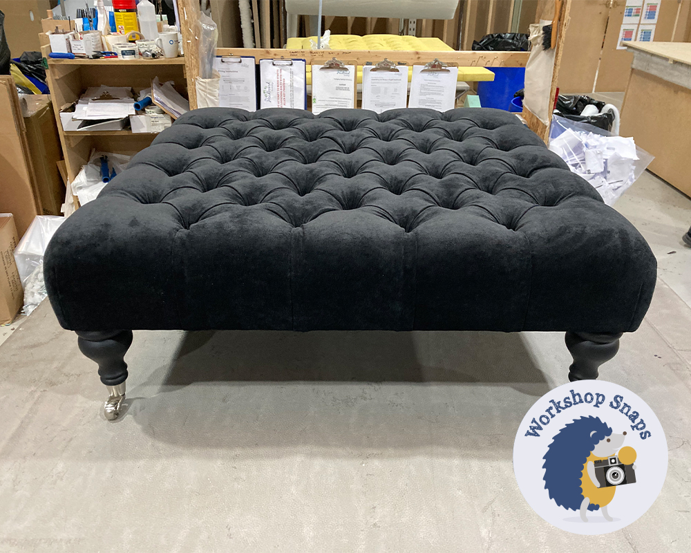 Large square black velvet fabric footstool with buttons and silver castors
