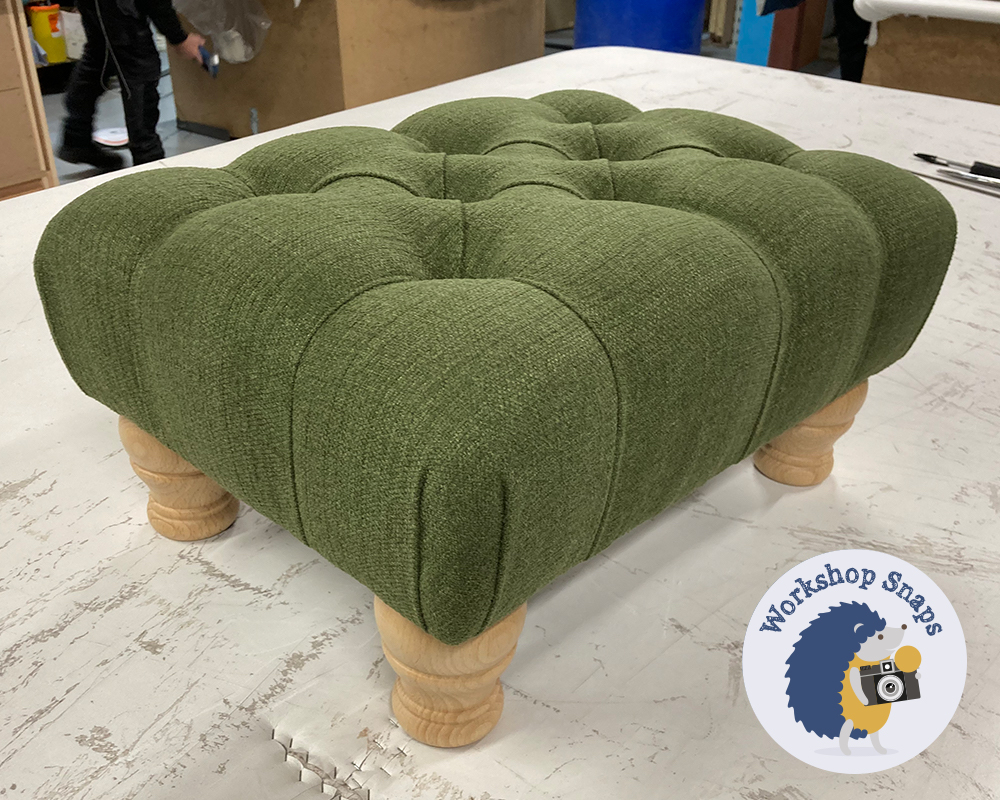 Very small rectangle padded footstool in green fabric with buttons