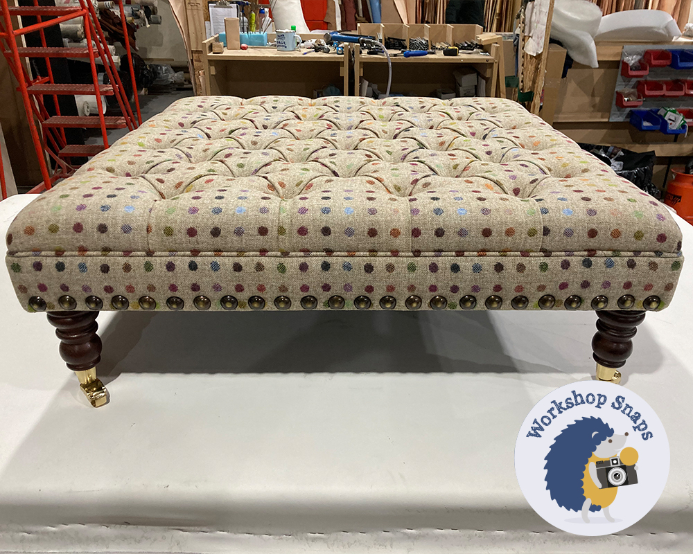 Large square spotty wool footstool with buttons castor legs